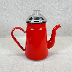 May include: A vibrant red enamel coffee pot with a curved handle and a long, slender spout. The pot features a shiny, silver-colored lid with small ventilation holes. The design is classic and functional.