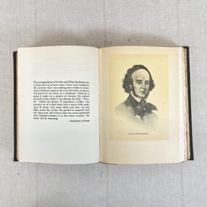 May include: An open book with text and a portrait of Felix Mendelssohn. The left page features printed text, while the right page displays a black and white portrait of a man with the name "FELIX MENDELSSOHN" below.