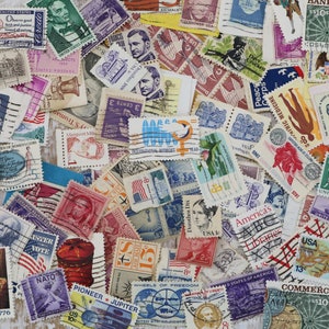 May include: A collection of vintage postage stamps from around the world. The stamps feature a variety of designs, including animals, people, and landmarks. Some of the stamps are in color, while others are in black and white. The stamps are arranged in a random pattern on a wooden surface.