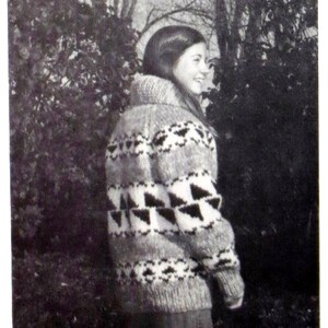 May include: A black and white patterned sweater with a high neck