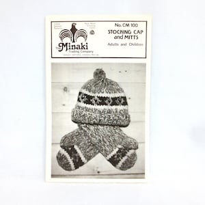 May include: Black and white knitting pattern for a stocking cap and mittens. The pattern is called "No. CM-100 Stocking Cap and Mitts" and is for adults and children. The Minaki Trading Company logo is in the top left corner.