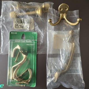 May include: A set of three ceramic mugs with a speckled, matte finish. The mugs are in shades of cream, light gray, and dark gray. Each mug has a simple, minimalist design and a rounded handle.