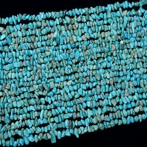 May include: A strand of turquoise chip beads, featuring a variety of shapes and sizes. The beads are a vibrant blue-green color and have a natural, irregular texture.