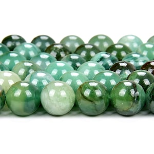 May include: A strand of round, green jade beads. The beads have a smooth, polished finish and a natural, marbled pattern.