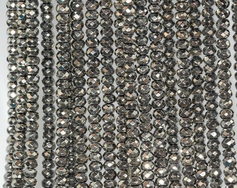 May include: A strand of faceted black hematite beads. The beads are small and round, with a shiny, metallic finish.