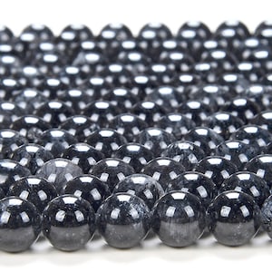 May include: A strand of black and silver gemstone beads. The beads are round and have a smooth, polished finish.