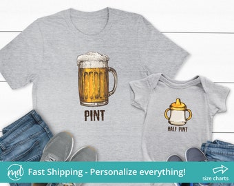 May include: A gray t-shirt with a drawing of a beer mug and the word "PINT" underneath. A smaller gray t-shirt with a drawing of a baby bottle and the words "HALF PINT" underneath.