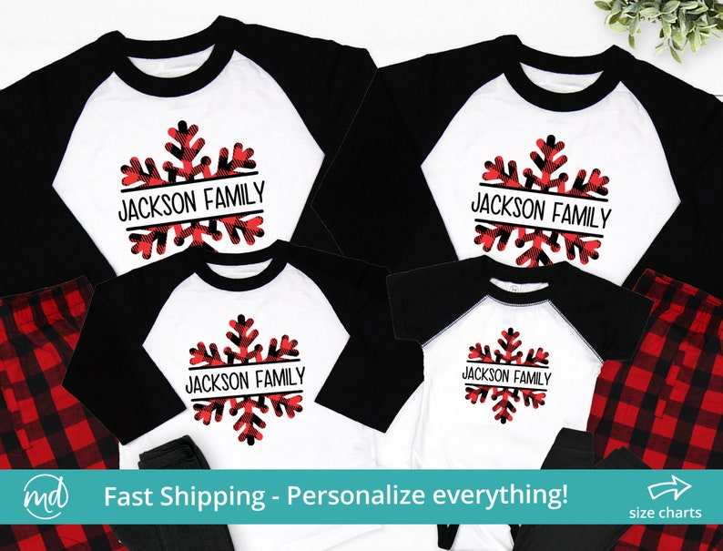May include: A set of four matching pajamas featuring a red and black plaid pattern with a white snowflake design. The snowflake has a black border and the text "JACKSON FAMILY" written across it.