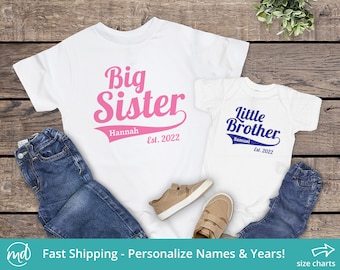 May include: Two white t-shirts with the text "Big Sister" in pink and "Little Brother" in blue. The shirts are personalized with the names "Hannah" and "Samuel" and the year "Est. 2022".