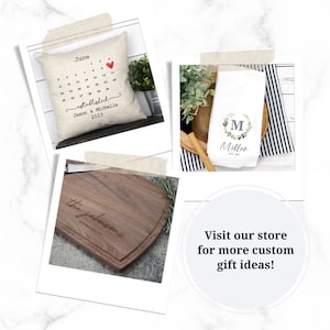 May include: Three personalized gifts: a pillow with a calendar design and the text "established Jason & Michelle 2023", a kitchen towel with a wreath and the text "M Miller est. 2023", and a wooden cutting board with the text "the johnsons established 2023".