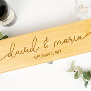 May include: A wooden wine box with a personalized inscription that reads "david & maria" and "SEPTEMBER 2, 2023".