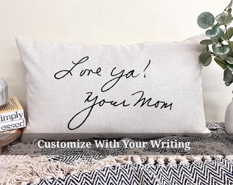 May include: White throw pillow with black cursive writing that says "Love ya! your mom".