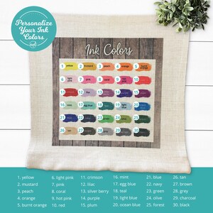 May include: A pillow with a woodgrain background and a chart of 30 different ink colours. Each colour is labelled with a number and a name. The text "Ink Colours" is at the top of the chart.