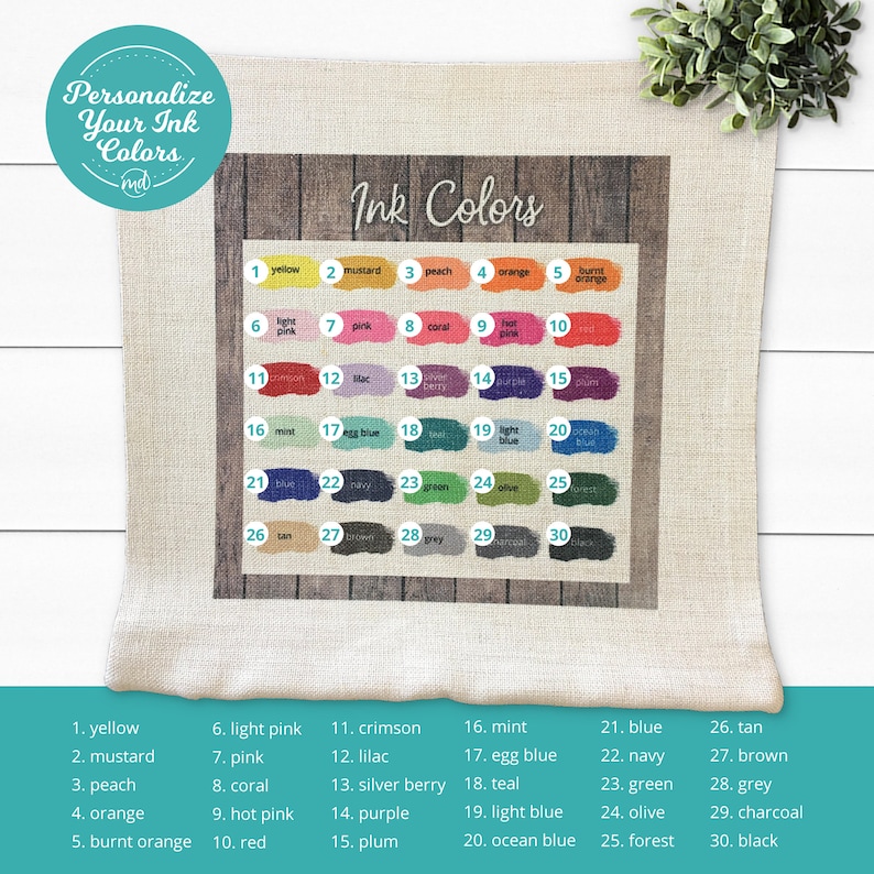 May include: A pillow with a woodgrain background and a chart of 30 different ink colours. Each colour is labelled with a number and a name. The text "Ink Colours" is at the top of the chart.