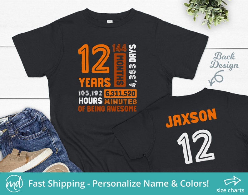 May include: Black t-shirt with orange text that reads "12 Years 105,192 Hours 6,311,520 Minutes of Being Awesome" and "144 Months 4,383 Days". The back of the shirt has the name "Jaxson" and the number "12" in white.