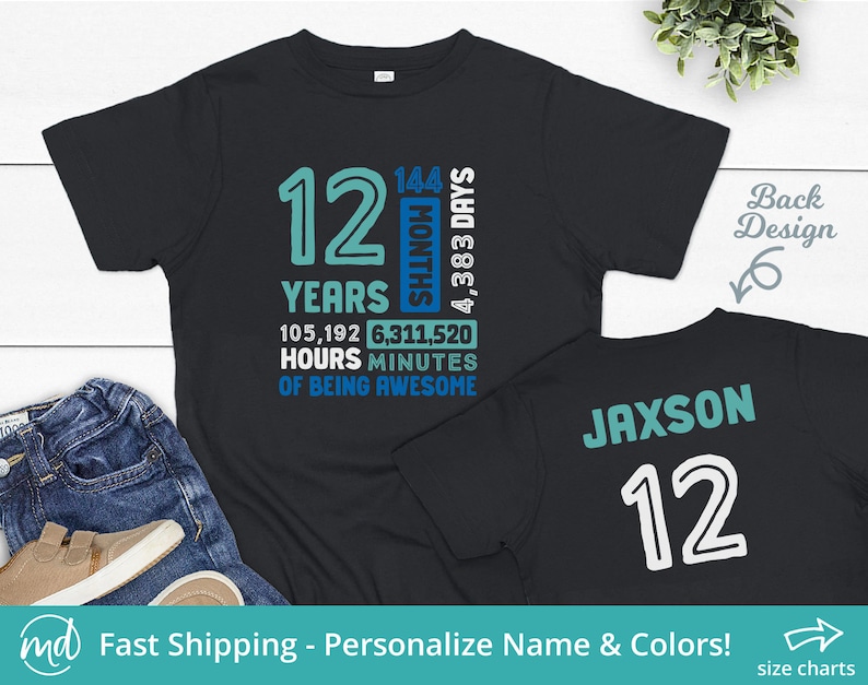 May include: Black t-shirt with a blue and white design celebrating a 12th birthday. The front of the shirt shows the number 12 with the text "Years", "Months", "Days", "Hours", and "Minutes". The back of the shirt has the name "Jaxson" and the number "12" in white.