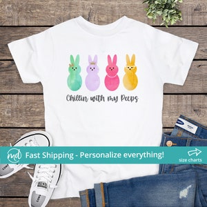 May include: White t-shirt with a graphic of four pastel-colored Peeps with different accessories. The text "Chillin with my Peeps" is printed below the graphic.