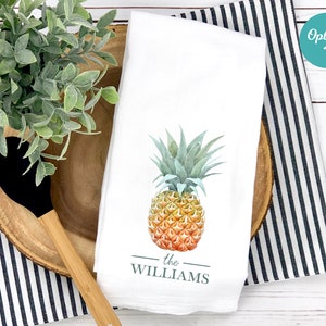 May include: White kitchen towel with a watercolor illustration of a pineapple and the text "the WILLIAMS" printed below.