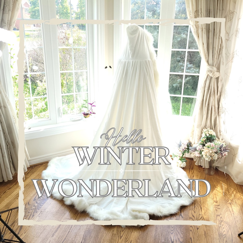A white hooded cape made of luxurious velvet with delicate white trim. The cape features a small train, adding an elegant touch. Ideal for winter weddings, providing warmth and a glamorous feel.
