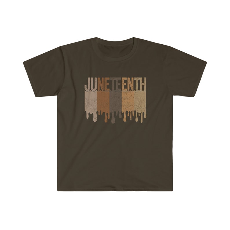 May include: A brown t-shirt with the word "Juneteenth" printed in white letters. The letters are dripping with brown, tan, and light brown paint.