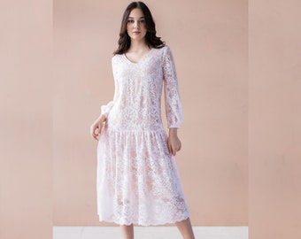 May include: A white lace dress with a V-neck and long sleeves. The dress has a tiered skirt and a delicate floral pattern. The dress is knee-length and appears to be made of a sheer fabric.