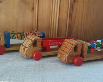 Set of 3 wooden trucks for counting and spelling