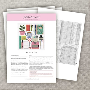 May include: A cross stitch pattern for a colorful illustration of a desk with a typewriter, pencils, a cup of coffee, and the words "At My Desk". The pattern is 140 stitches wide by 140 stitches high.