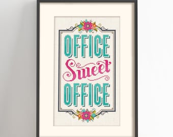 May include: Cross-stitch pattern with a white background and a framed design. The design features a teal and pink floral motif with the text "Office Sweet Office".