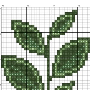 May include: Green leaf design cross stitch pattern with white X's on a white background.
