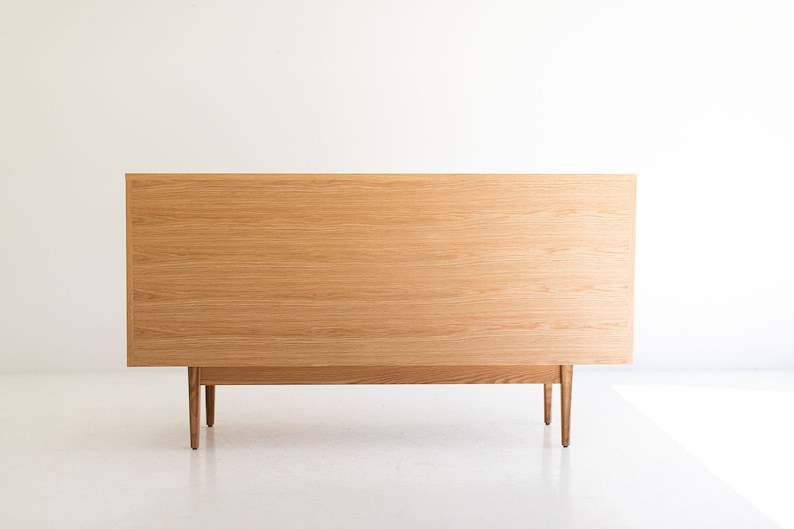 May include: A light wood dresser with four legs and a simple design.