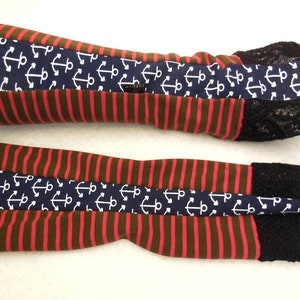 May include: A pair of red and brown striped arm warmers with a navy blue anchor print and black lace trim.