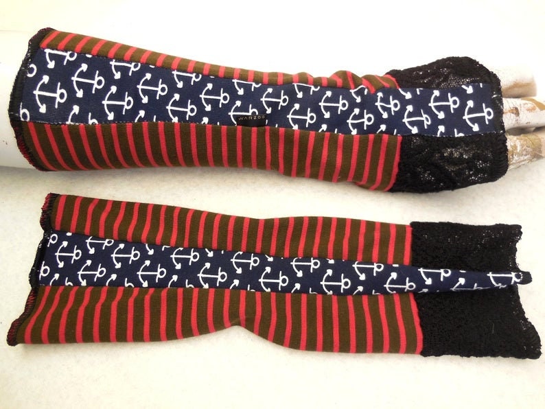 May include: A pair of red and brown striped arm warmers with a navy blue anchor print and black lace trim.
