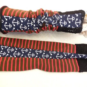 May include: A pair of red and brown striped arm warmers with a navy blue anchor print and black lace trim.