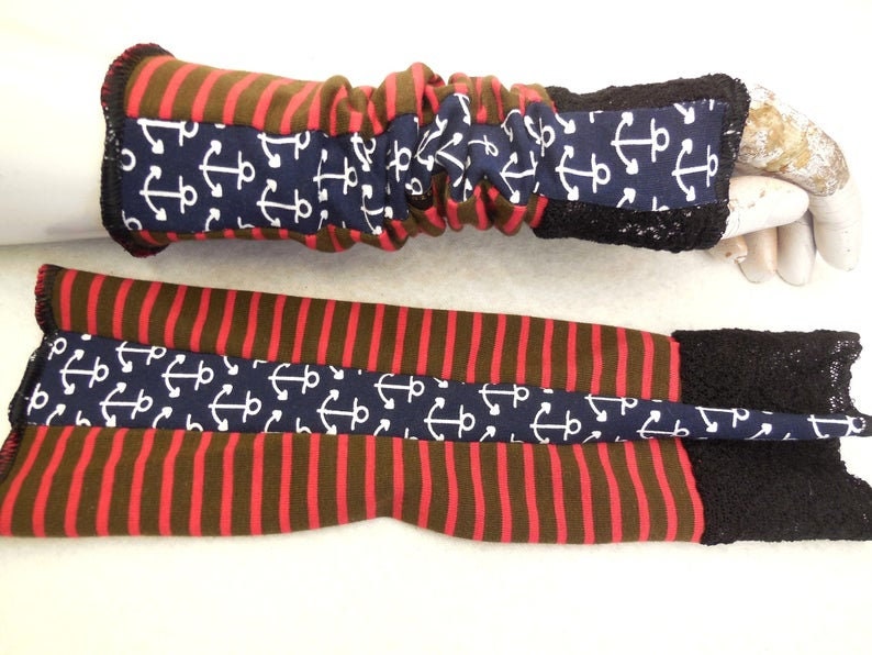 May include: A pair of red and brown striped arm warmers with a navy blue anchor print and black lace trim.
