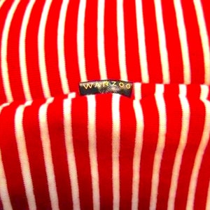 May include: Red and white striped fabric with a black label that says "WARZOG".