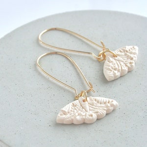 EARRING handmade in polymer clay, ivory color, butterfly shape pendant on a long (gold or silver) hoop.