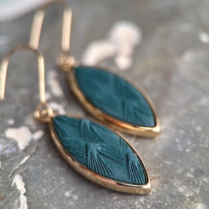 EARRING, mid-length hook, gold or silver elipse shape pendant with (teal, beet, ivory) color polymer clay piece with art deco pattern.