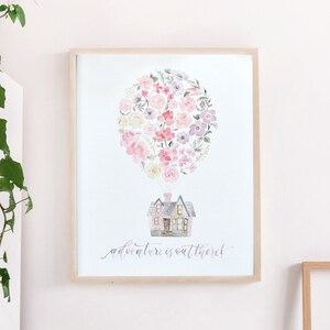 May include: A framed watercolor print of a house floating in a hot air balloon made of flowers. The text "adventure is out there" is written in cursive below the house.