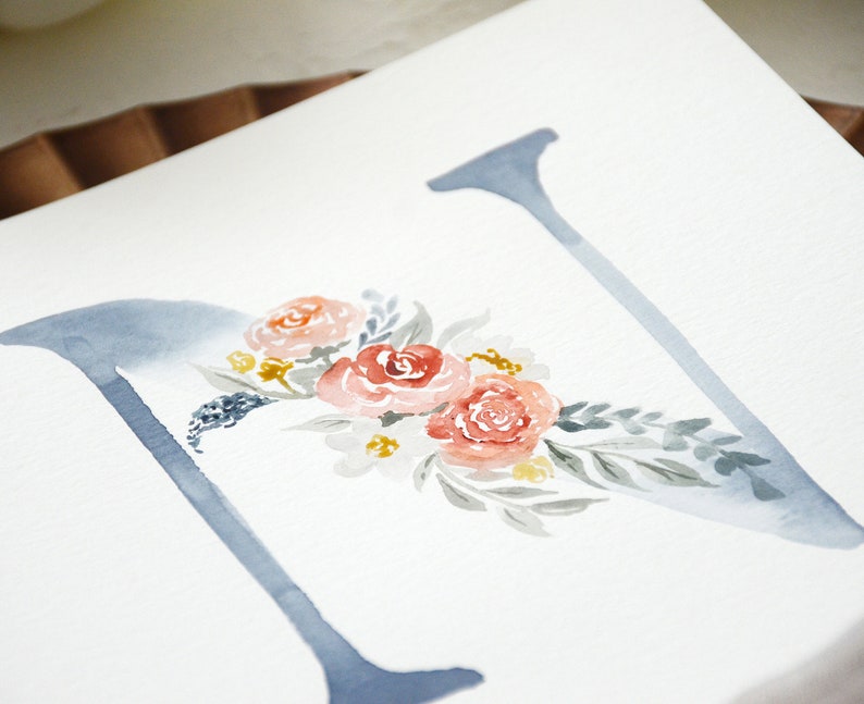 May include: Watercolor painting of the letter N with a floral design. The letter is painted in a light blue color and the flowers are in shades of pink, red, and yellow.