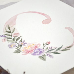 May include: A watercolor painting of the letter C with pink and purple flowers and leaves.