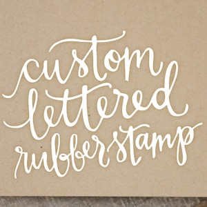 May include: White text on a brown background reads "custom lettered rubber stamp".