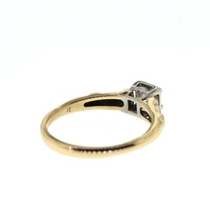 May include: A gold and silver engagement ring with a single diamond set in a square shape.