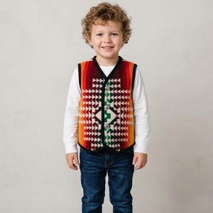 May include: A sleeveless vest featuring a vibrant, multi-colored geometric pattern in shades of red, orange, yellow, green, and black. The vest has a V-neckline, black trim along the edges, and three silver-toned buttons down the center front.