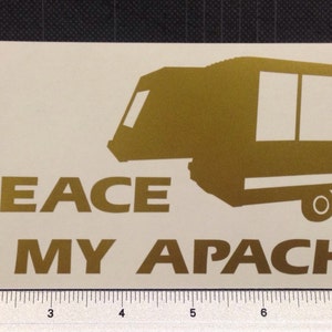 May include: Gold vinyl decal with a silhouette of a camper and the text "AT PEACE IN MY APACHE".