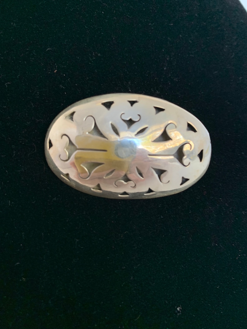Sterling silver ornate brooch from Mexico.