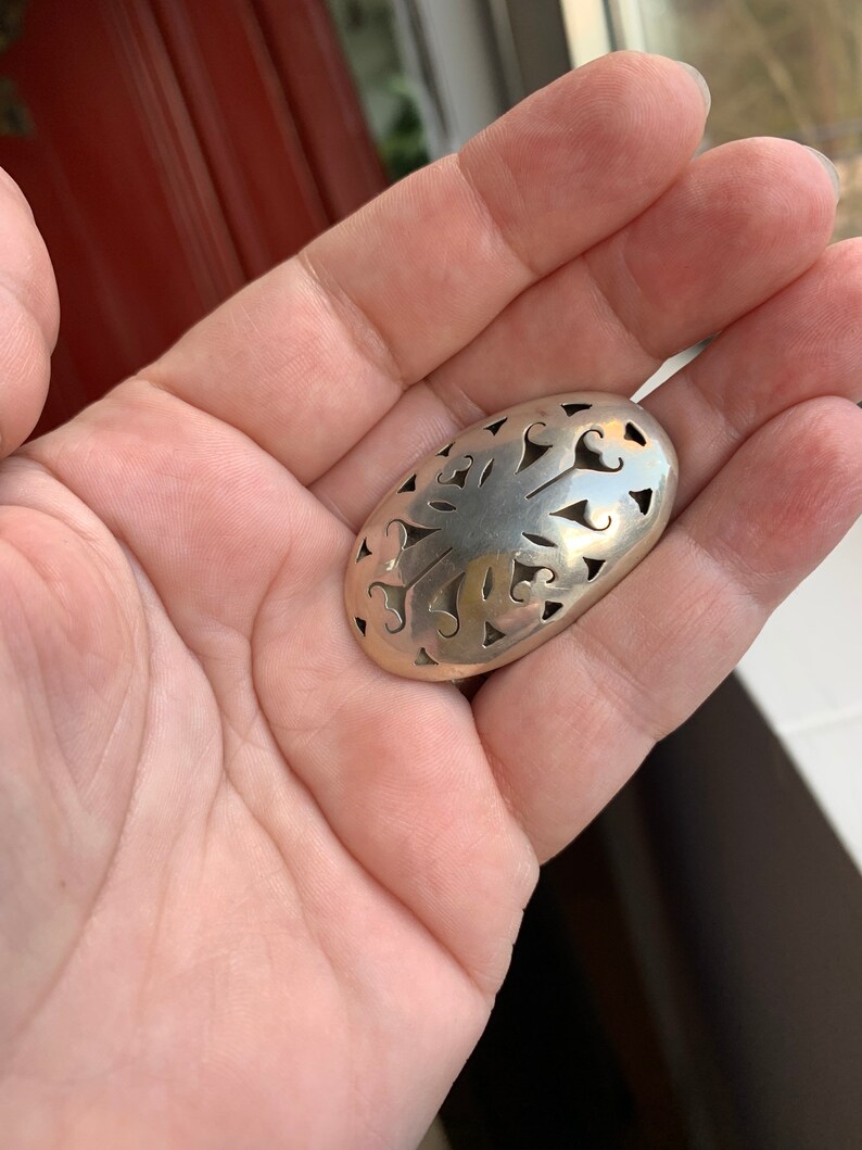 Sterling silver ornate brooch from Mexico.
