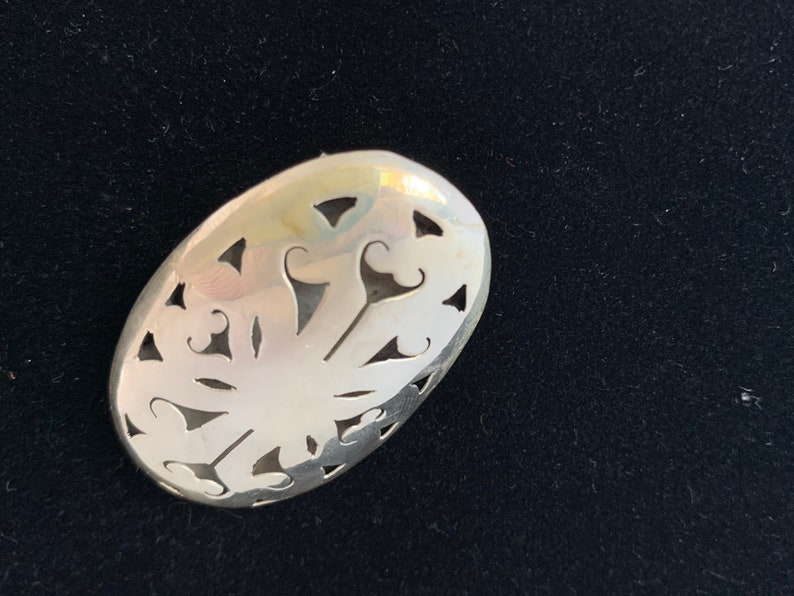 Sterling silver ornate brooch from Mexico.