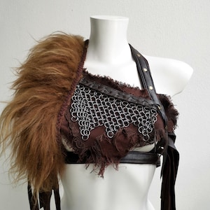 Fantasy warrior breastplate, brown leather fringe crop top. Fringed chainmail armor piece with shoulder fur. Barbarian pagan viking costume