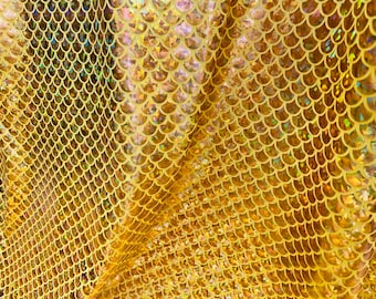 May include: Gold iridescent fabric with a mermaid scale pattern. The fabric is shiny and has a textured surface.