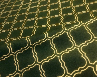 Puede incluir: Tela verde con un patrón geométrico dorado. El patrón es un diseño repetitivo de cuadrados y círculos entrelazados.